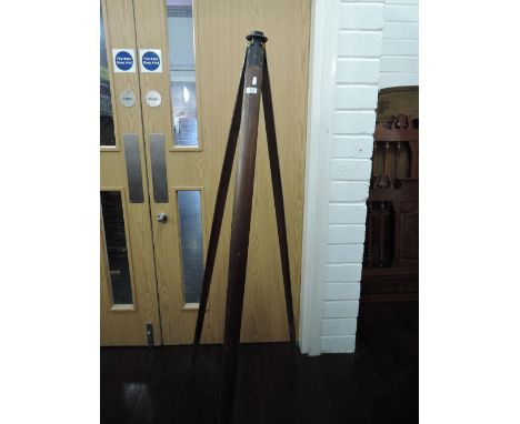 A vintage tripod stand for surveyors level