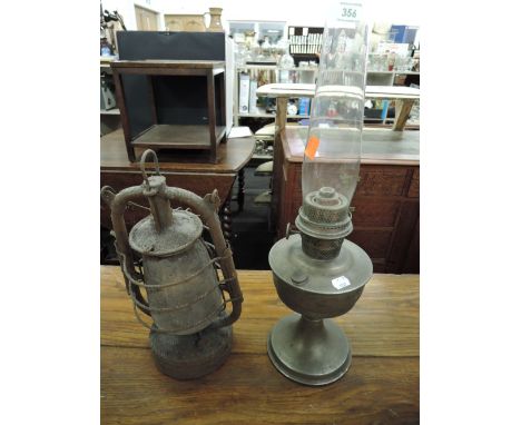 A vintage storm lantern and similar oil lamp by Aladin 