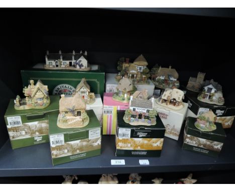 A shelf of Liliput lane studies including The Toy Menders, The Dog House, Wensleydale Heifer etc, all boxed
