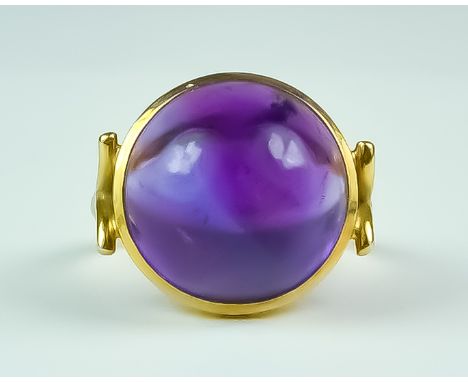 A Cabochon Amethyst Ring, Early 20th Century, 16mm diameter, set in 22ct gold, size Q, gross weight 7.6gCondition Report - Th