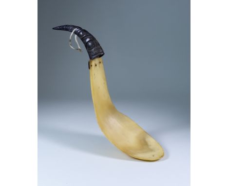 A North-West Coast Carved Horn Ladle of two-piece form, the black handle carved with animal totems, 15ins overall,Condition R