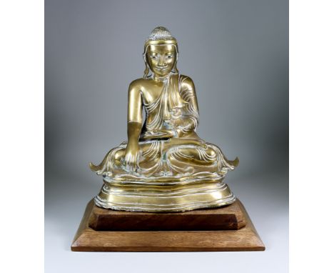 A Cast Brass Figure of a Seated Buddha, 14.5ins (36.9cm) high with wooden standCondition Report - The Buddha appears to be of