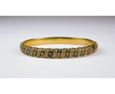 A Gold Bangle, Late 19th/ Early 20th Century, 15ct gold, floral and band decoration to the upper half, hinged with clasp, cir