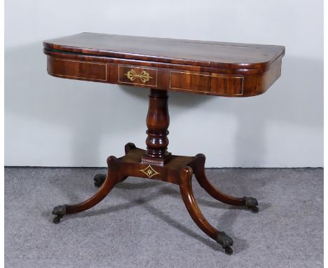 A George IV Rosewood D Shaped Card Table, inlaid with brass stringings, the green baize lined folding top on baluster turned 