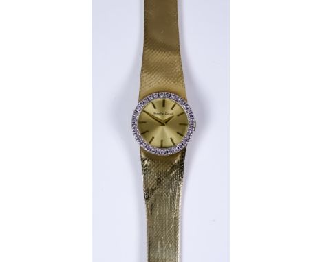 A Lady's Bueche Girod Manual Wind Wristwatch, 9ct gold with diamond set bezel, 24mm diameter case, with gold dial, gold baton