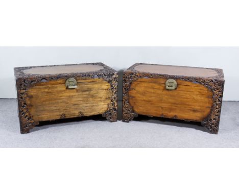 A Pair of Chinese Camphor Wood Chests, the lids and fronts carved with fruiting vines on stepped bracket feet, 40ins wide x 2