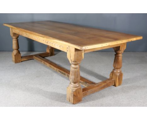 A 20th Century Oak Refectory Table, by S. & G. Bernthal of Faversham, with three-plank cleated top on heavy turned supports a