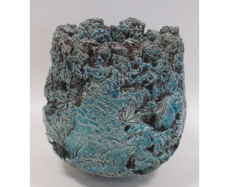 A 20th century pottery vase, the textured surface moulded with leaves and branches and glazed in turquoise 22cm high.Some sur