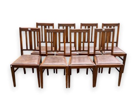 A set of eight mid 20th century mahogany stick back dining chairs, with bead carved top rails and drop in seats