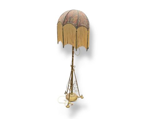 A brass telescopic standard lamp with fringed shade, 174cm high including shade