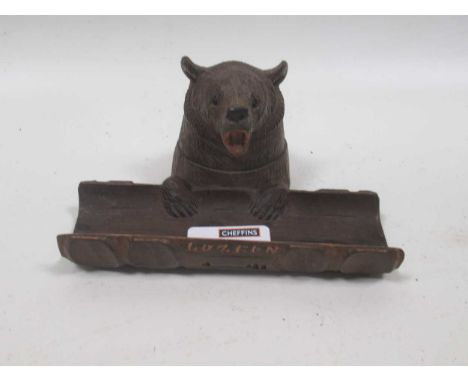 A Black Forest inkwell with carved wood flip top bear, 8 x 15cm