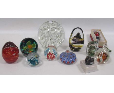A collection of glass paper weights to include Caithness, faceted with floral inclusion, a Caithness commemorative paperweigh