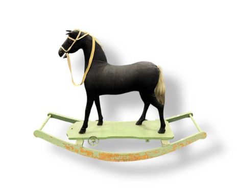 An Edwardian rocking horse, later fixed to a sleigh base, 95cms high x 135cm x 44cm