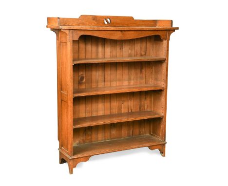 A Liberty style Arts & Crafts oak open bookcase, the gallery top with pierced back over three adjustable shelves raised on br