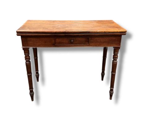 A 19th century mahogany tea or card table with fold over top, set on turned legs and the frieze fitted with a single small dr