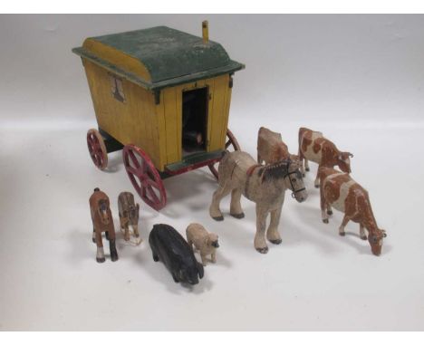 A collection of charming larger scale carved and painted wood farm animals, including goats, sheep, donkey, plough horse, cow