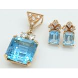 A Head-Turning 18K Gold, Blue Topaz and Diamond Pendant and Earring Set. A 10ct princess cut ice
