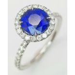A PLATINUM DIAMOND & SAPPHIRE HALO CLUSTER RING 2.05CT, 4.1G TOTAL WEIGHT, SIZE M, ROUND NATURAL