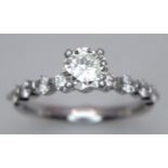A 14K WHITE GOLD DIAMOND SOLITAIRE WITH DIAMOND SHOULDERS 0.60CT ROUND CENTRE DIAMOND WITH 0.40CT