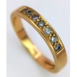An 18K Yellow Gold Seven Stone Channel Set Diamond Ring. Size K. 3.1g