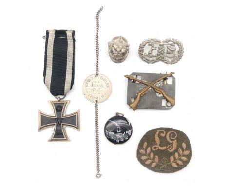 A WW1 Imperial German Iron Cross, a small German white metal and enamel portrait locket, a Lewis Gunner's embroidered cloth p