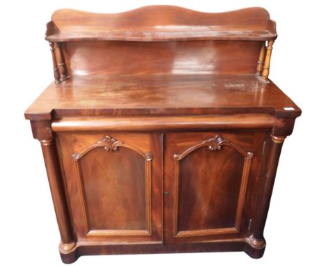 A late Victorian mahogany chiffonier with shelved back splash over single frieze drawer over pair of panel doors on plinth ba
