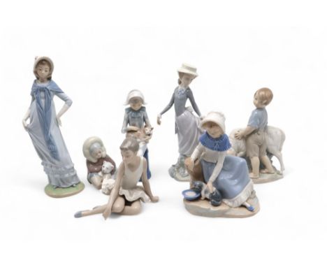 A Lladro Eskimo and polar bear cub, another of a girl and assorted Nao figures of children Condition Report:Available upon re