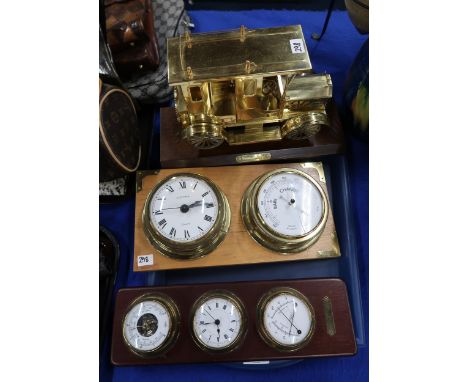 A brass model of a vintage taxi and two barometers Condition Report:Available upon request