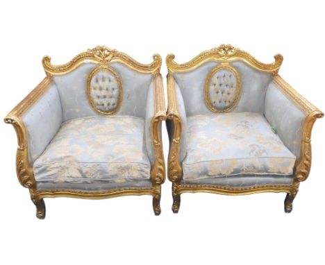 A pair of 20th century Louis XV style gilt framed scroll armed armchairs with button upholstered panel to centre of back rest