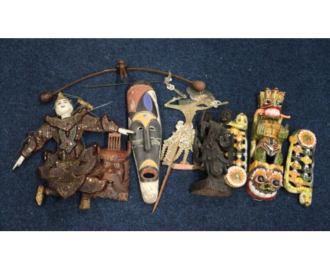 A large collection of tribal masks, an Indonesian shadow puppet, another marionette example etc Condition Report:Available up