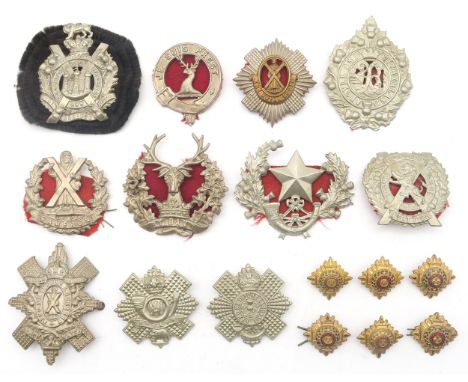 A collection of military cap badges, to include the London Scottish Regiment, King's Own Scottish Borderers with fringed rose