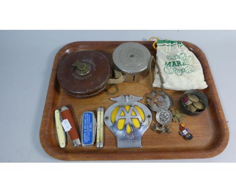 A Tray of Curios to Include Leather Cased Tape Measure, Midland Bank Vintage Money Box with Contents, AA Badge, Vintage Penkn