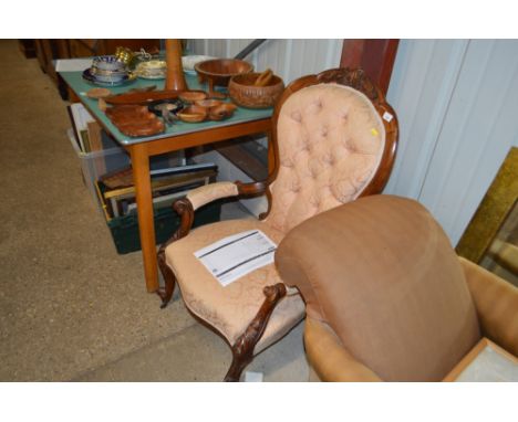 A Victorian button back armchair 