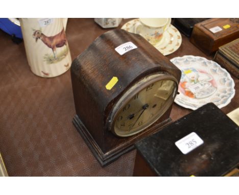 An oak cased two hole mantel clock 