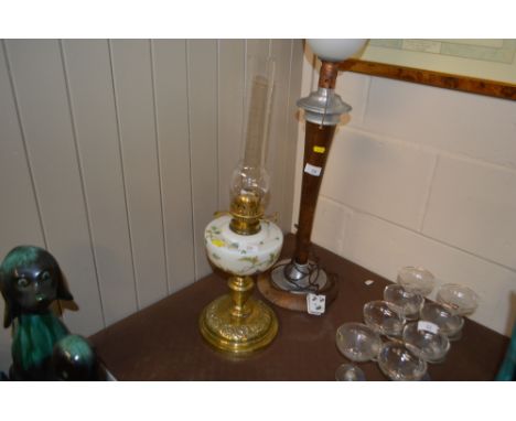 A brass oil lamp with glass reservoir 