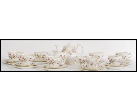 A vintage 20th century eight person fine English bone china tea service in the Fancy Free pattern consisting of teapot, milk 