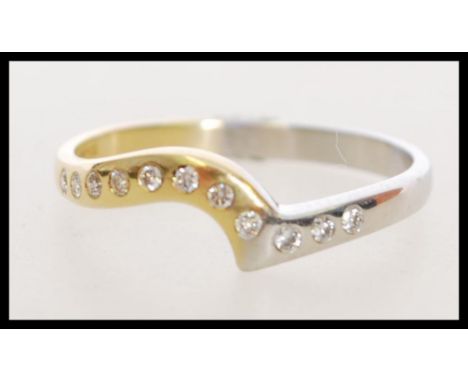 A 20th century hallmarked 18ct gold and diamond ring, with half being white gold and half being yellow, having 11 inset diamo