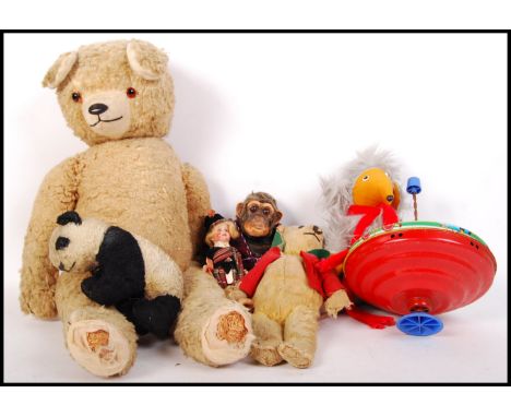 A collection of assorted vintage soft toy bears and dolls to include; 2 bears , panda , Chad Valley monkey and a womble along