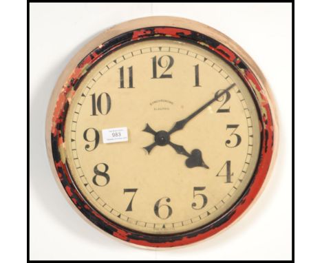 A vintage retro 20th century Synchrome industrial electric wall clock of circular form with faceted playing card spade hands.