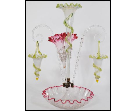 A 19th century Victorian Vaseline glass epergne centerpiece with a large central trumpet with a yellow fanned rim and embelli