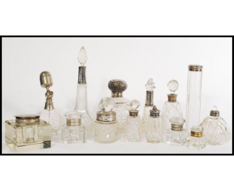 A selection of cut glass cruet and vanity items, with many having silver tops to include a hallmarked Roberts &amp; Belk cut 