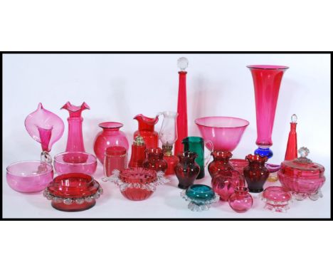 A collection of Victorian 19th century and 20th century cranberry glass to include a good tall vase with blue glass knop stem