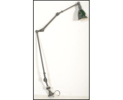 An early 20th century retro industrial work anglepoise lamp, with a pendant shade, stamped Dugdill to the base.&nbsp;Measures