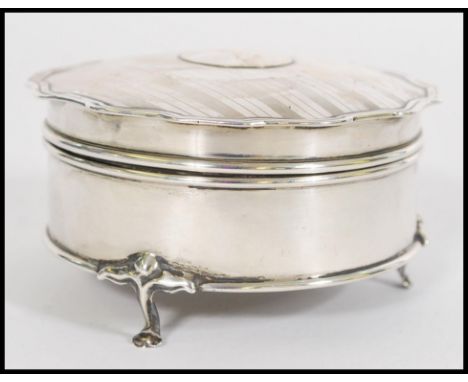 A silver hallmarked ladies dressing table pill pot&nbsp; being raised on hoof feet&nbsp; with engine turned top being hallmar