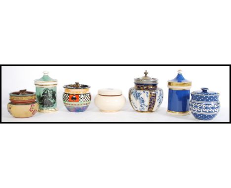 A selection of vintage tobacco jars to include a green jar with a concave lid with gilt work to the rim and a scene with a la
