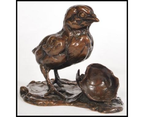 A bronze figurine of a chick and egg by Lucy Kinsella, signed to the base 'Kinsella', limited edition number 1/20. Measures 1