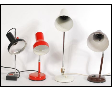 A group of four vintage retro 20th century anglepoise desk lamps. Three raised on circular bases with conical pendant shades 