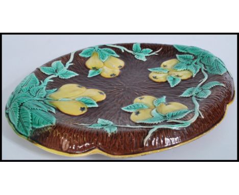 A 19th century Victorian Majolica ceramic bread board plate depicting pears and vine on brown log ground.&nbsp;Measures 32cm-