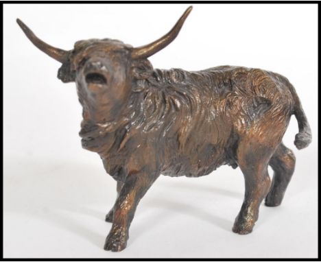 A bronze figurine of a highland cow in motion by Michael Simpson, stamped MS to the base, limited edition number 8/50. Measur