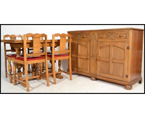 A 1930's Art Deco oak dining room suite comprising a light oak draw leaf refectory dining table , set of matching dining chai